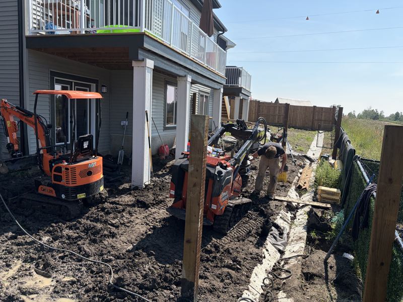 Augering fence post holes with mini equipment