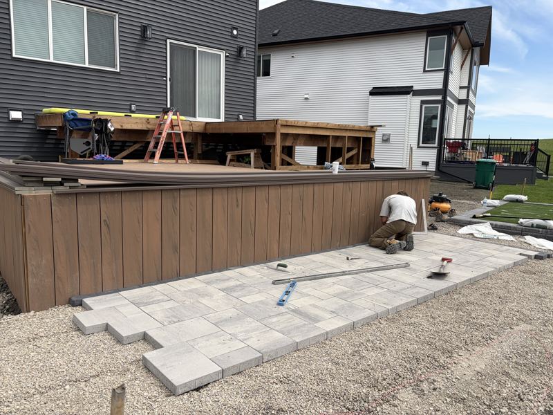 Deck framing going up while the patio is laid