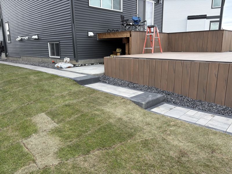 Composite deck skirting with a paver walkway and steps