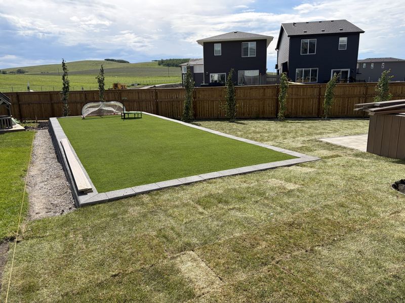 Block retaining wall around a raised turf area
